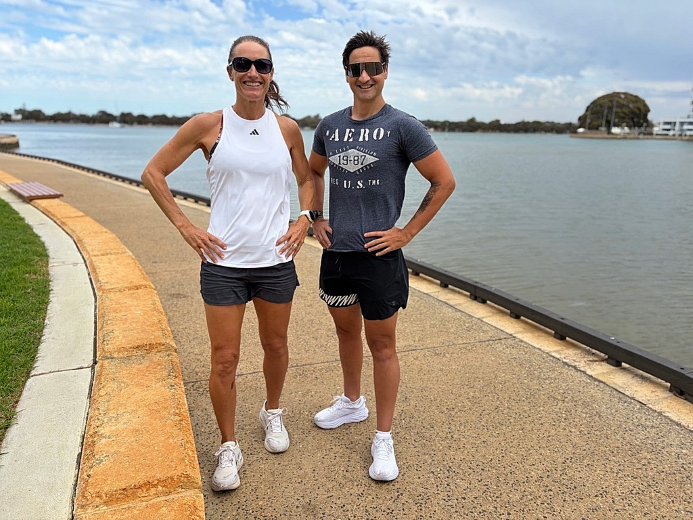 two people standing near the water